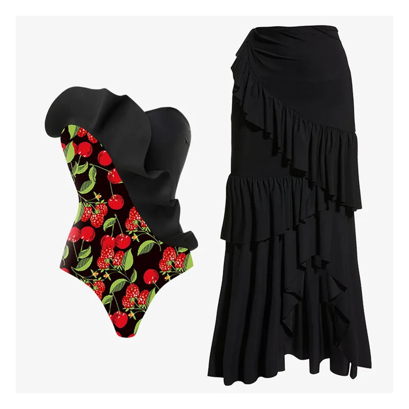 Strapless swimsuit with ruffled black overlay and cherry print, accompanied by a ruffled black midi skirt.