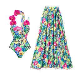 Geometric and floral print one-piece swimsuit and maxi skirt laid flat showing detail