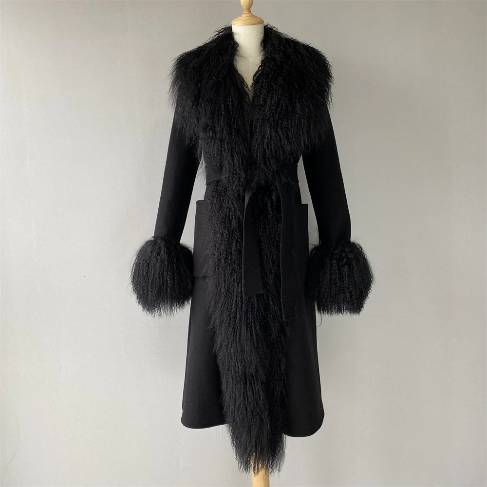 Black coat with fur trim on a mannequin against a plain background