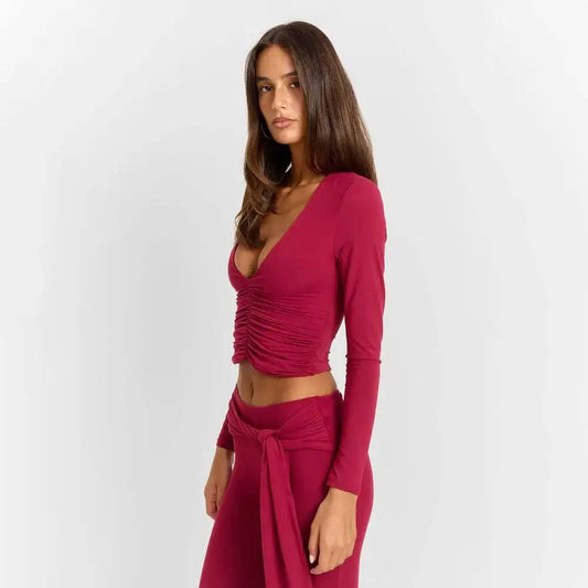Close-up of the ruched v-neck detail on a long sleeve crop top.