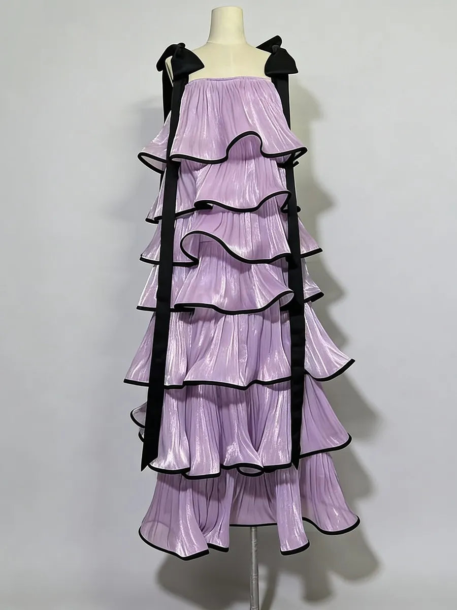 Purple dress with black ruffles on a mannequin against a white background