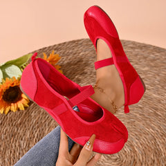 Close-up of red split toe ballet flats on foot