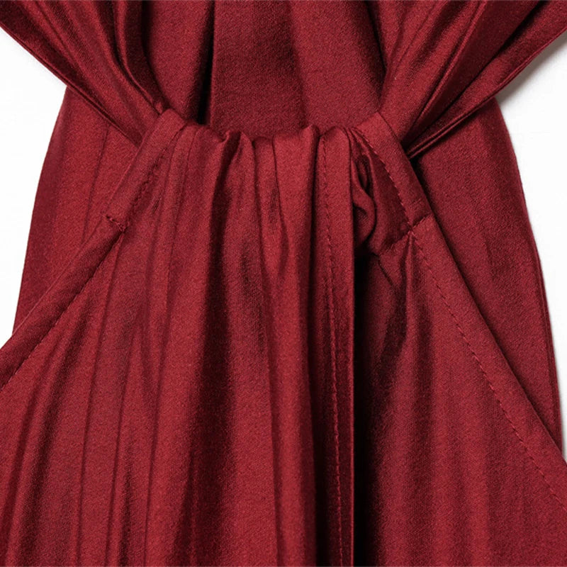 Close-up of a red fabric with a tie detail on a white background