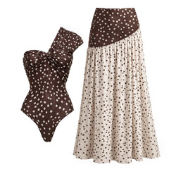 Polka dot one-piece swimsuit and flowing maxi skirt displayed together.