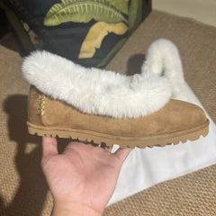 Side profile of a fur trimmed suede ballet flat