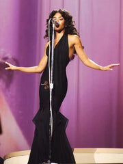 Performer in a black halter neck ruffle mermaid dress singing