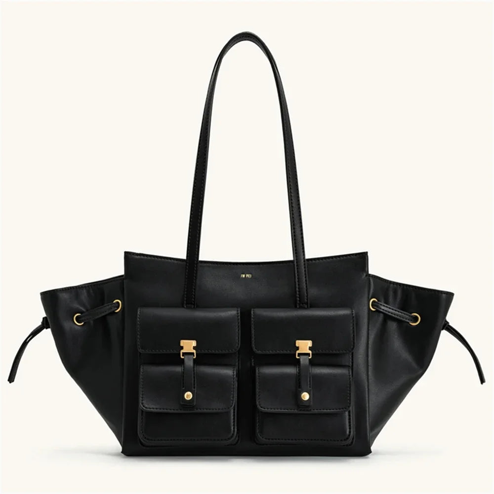 Black leather handbag with gold accents on a white background