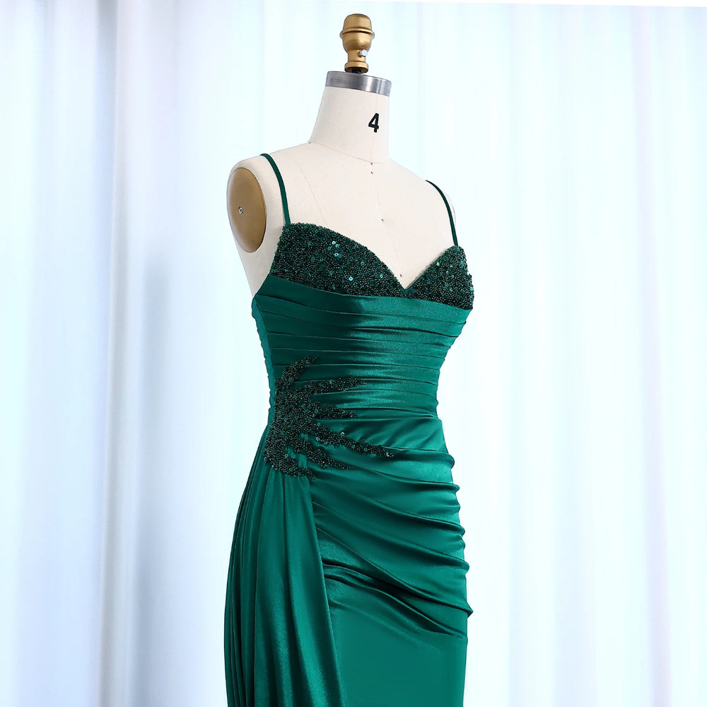 Green evening gown on a mannequin against a light background