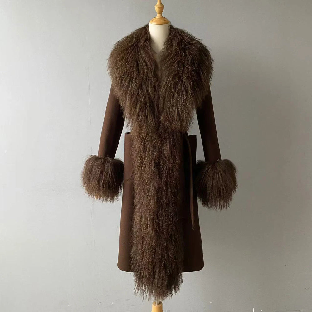 Brown coat with fur trim and cuffs on a mannequin against a plain background