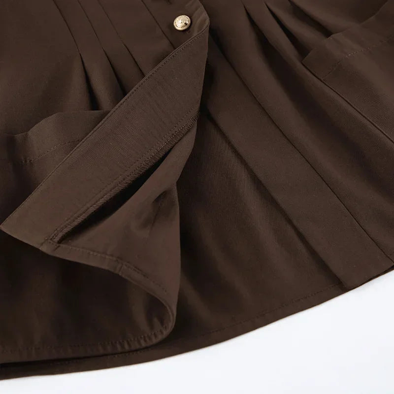 Close-up of a brown fabric with a button on a white background