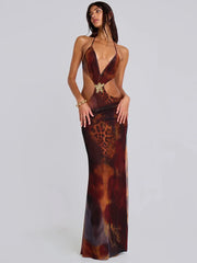 Woman wearing a leopard print evening gown on a plain background