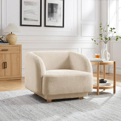 Beige armchair in a living room setting with wooden furniture and decor.