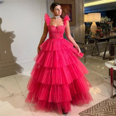 Golden Atelier red A-line prom dress with delicate ruffle straps, a fitted bodice, a flowing A-line skirt with layers of airy tulle, modeled on a woman in a formal setting. Red 1