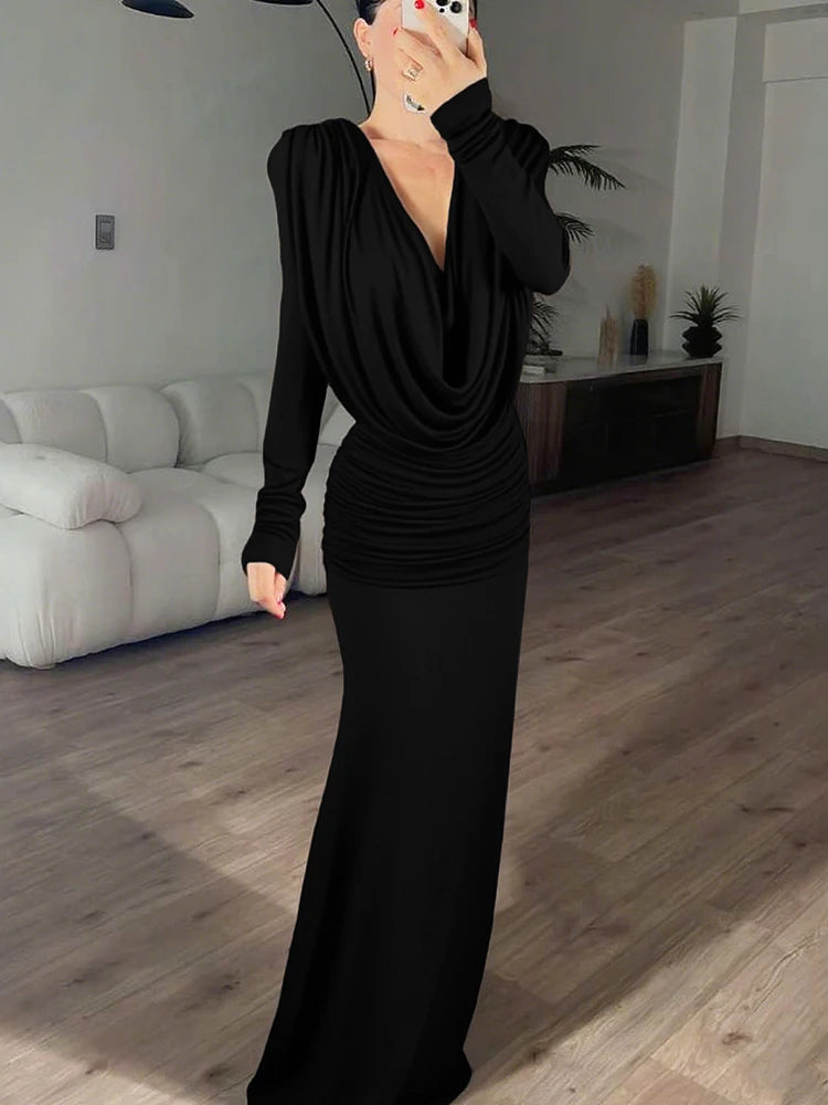 Person wearing a black dress in a living room setting