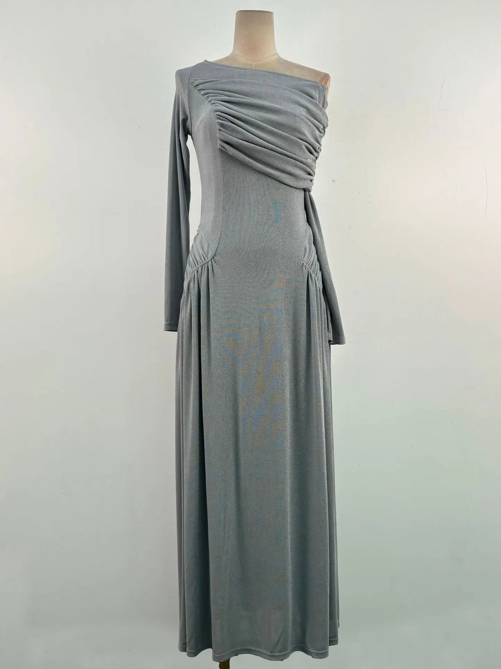 Gray one-shoulder dress on a mannequin against a white background