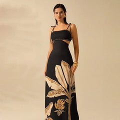 Woman wearing a black dress with gold leaf patterns on a beige background
