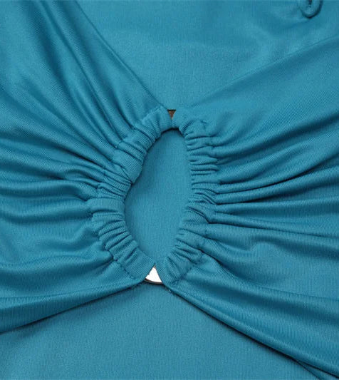 Close-up of a blue fabric with a pleated design on a light gray background