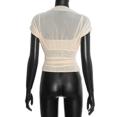 Mannequin wearing a beige sheer top on a white background