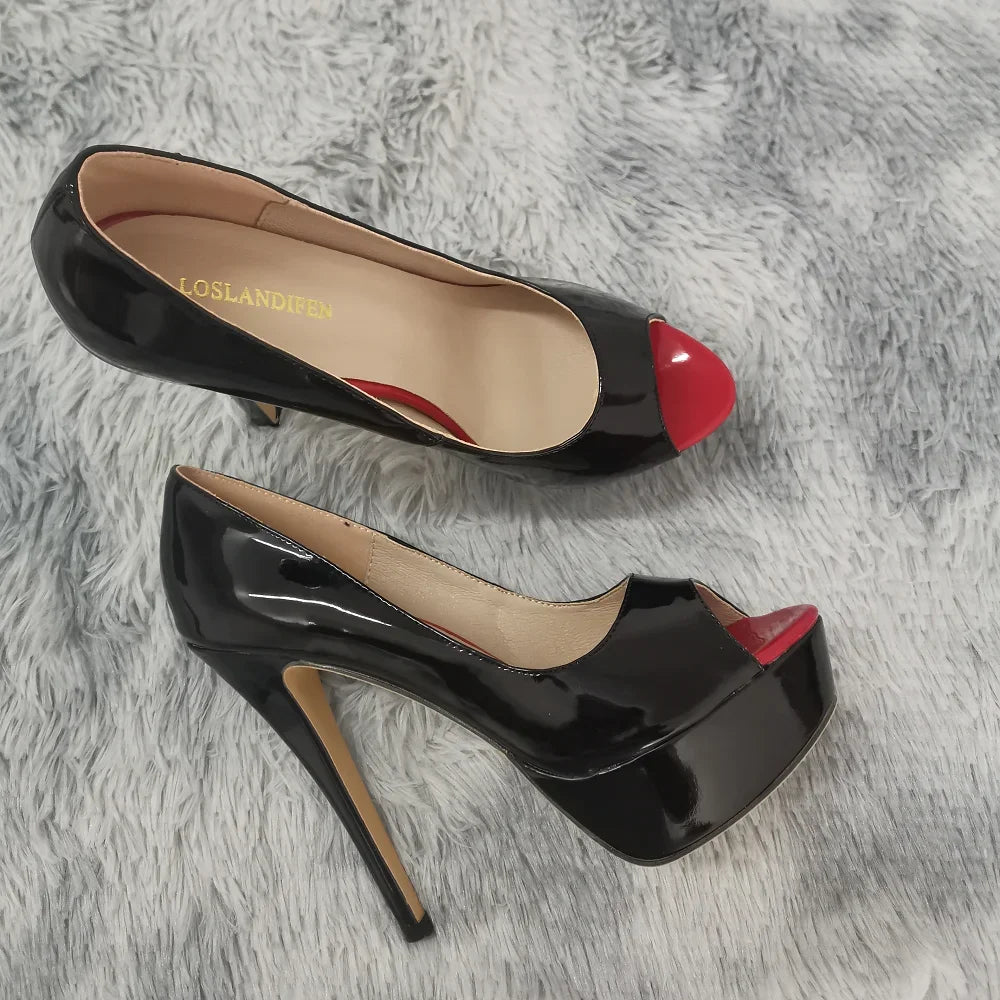 Black high-heeled shoes with red accents on a gray textured surface