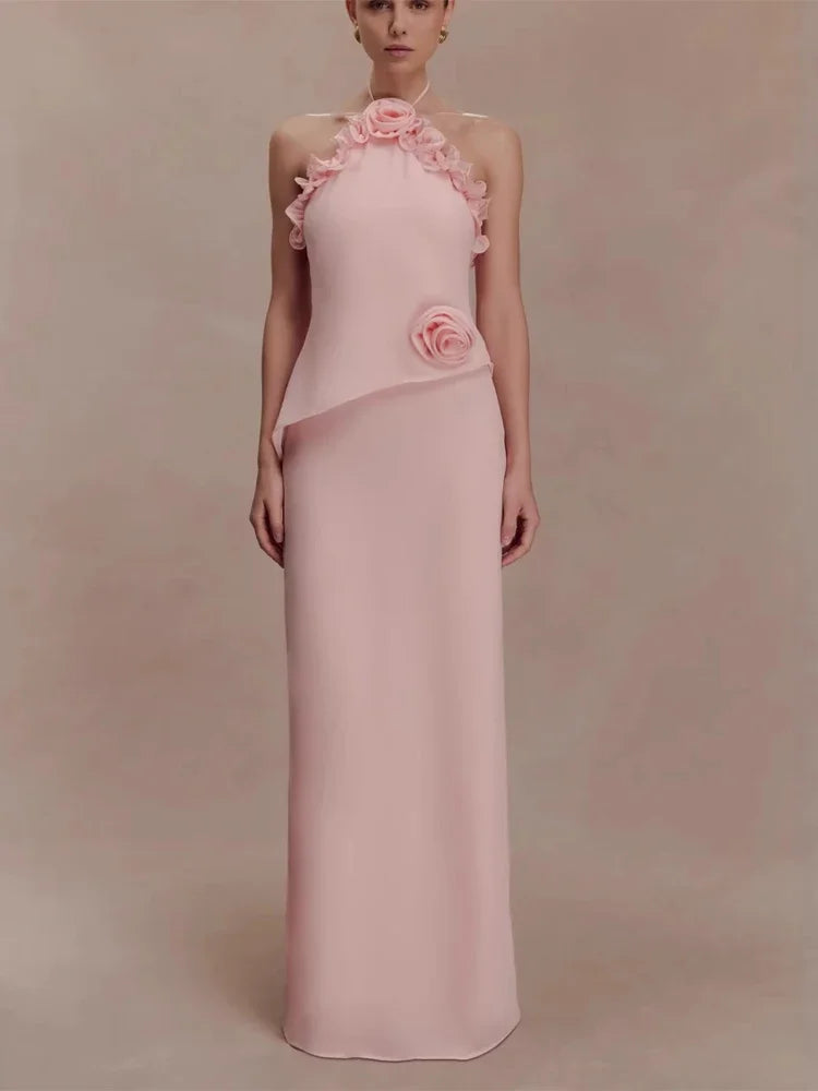 Pink evening gown with floral details on a plain background
