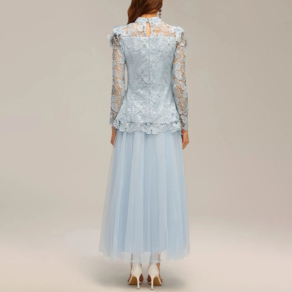 Light blue lace dress with sheer sleeves on a plain background