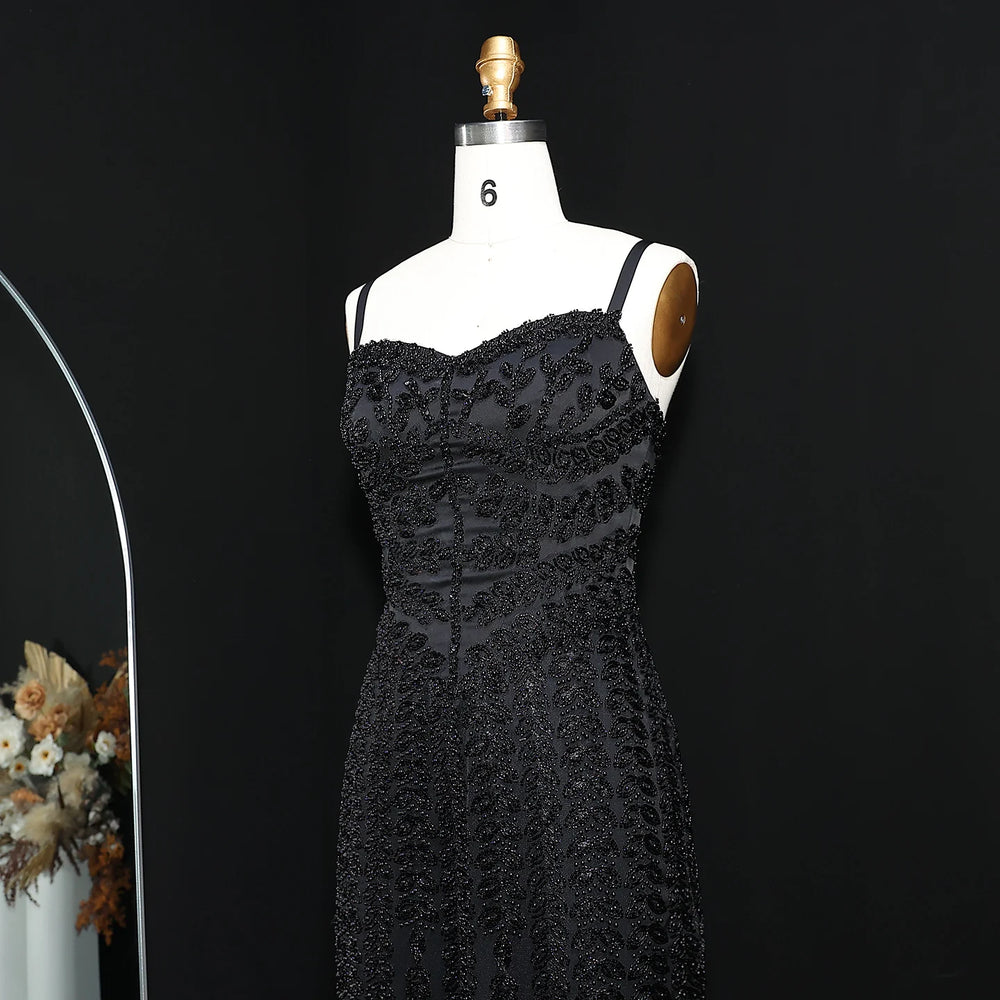 Black lace dress on a mannequin against a black background