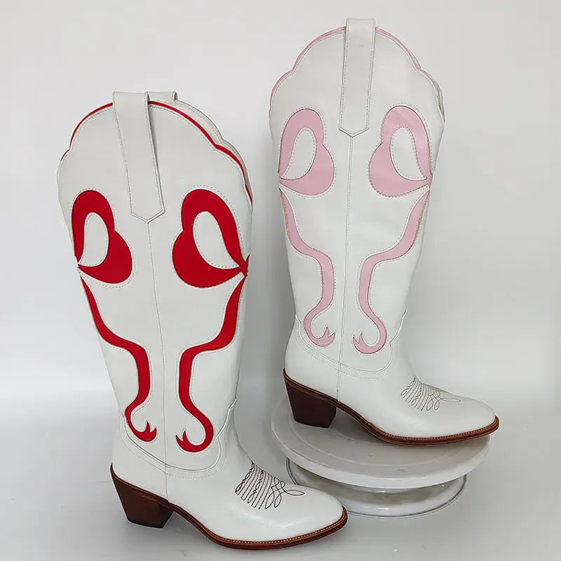 White cowboy boots with red and pink designs on a white background