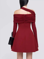 Red one-shoulder dress with long sleeves on a plain background