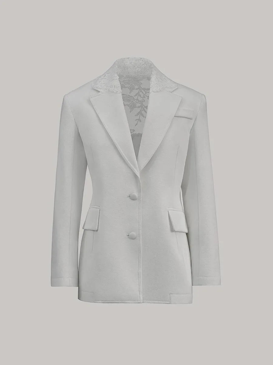 Light gray blazer with lace trim on a light gray background