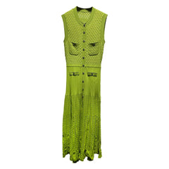 Green sleeveless dress with button details on a white background