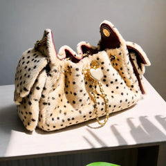 Leopard print faux fur bucket bag on a white surface with natural light