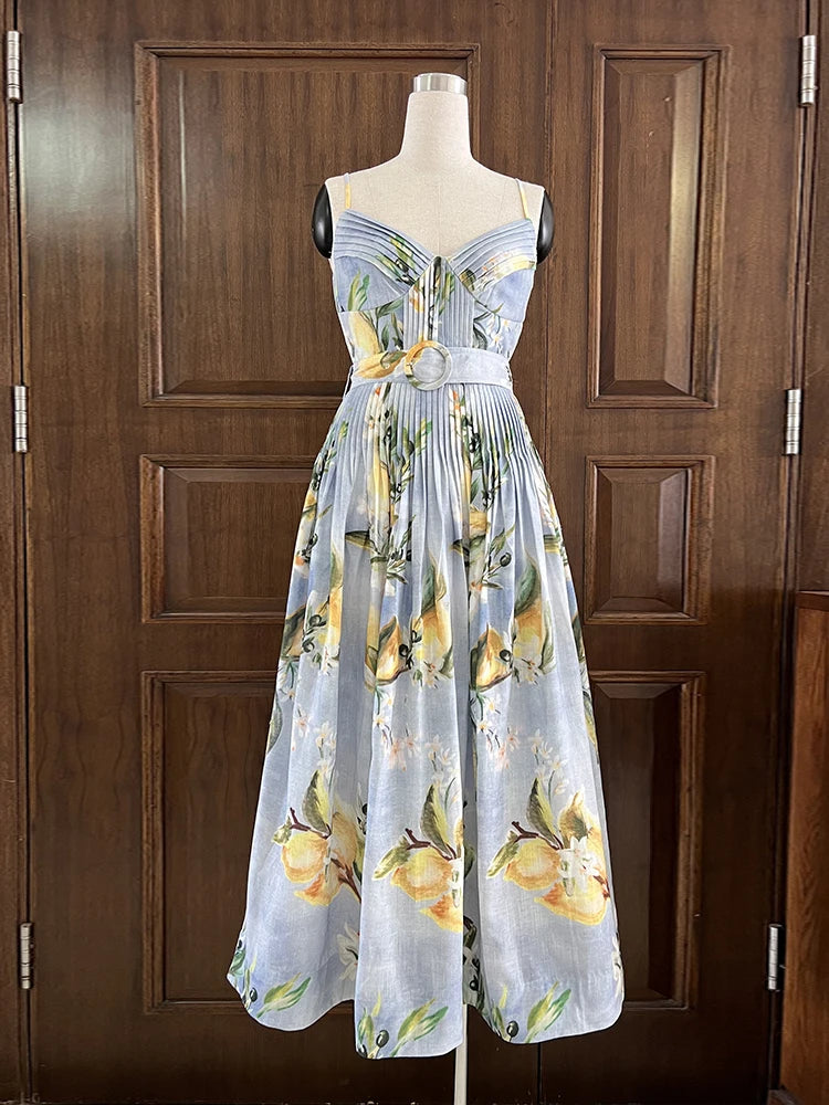 Dress with lemon pattern on a mannequin against a wooden door background