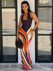 Swirl print halter neck maxi dress worn outdoors