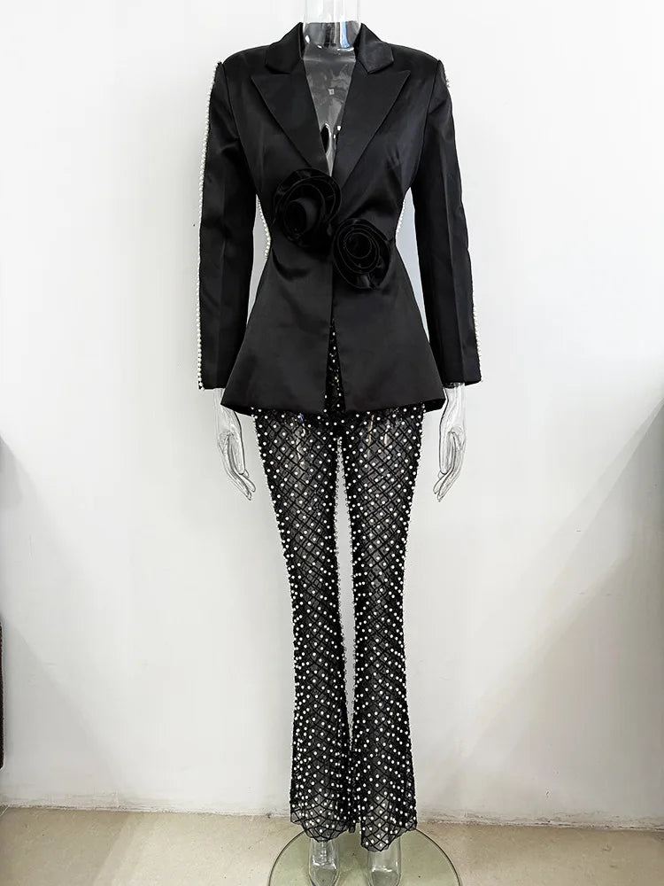 Black blazer and polka dot pants on a mannequin against a white background