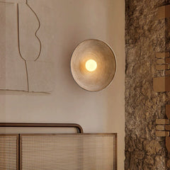 A tranquil living room featuring a Japanese wall sconce as an accent piece, casting soft shadows on the walls. C