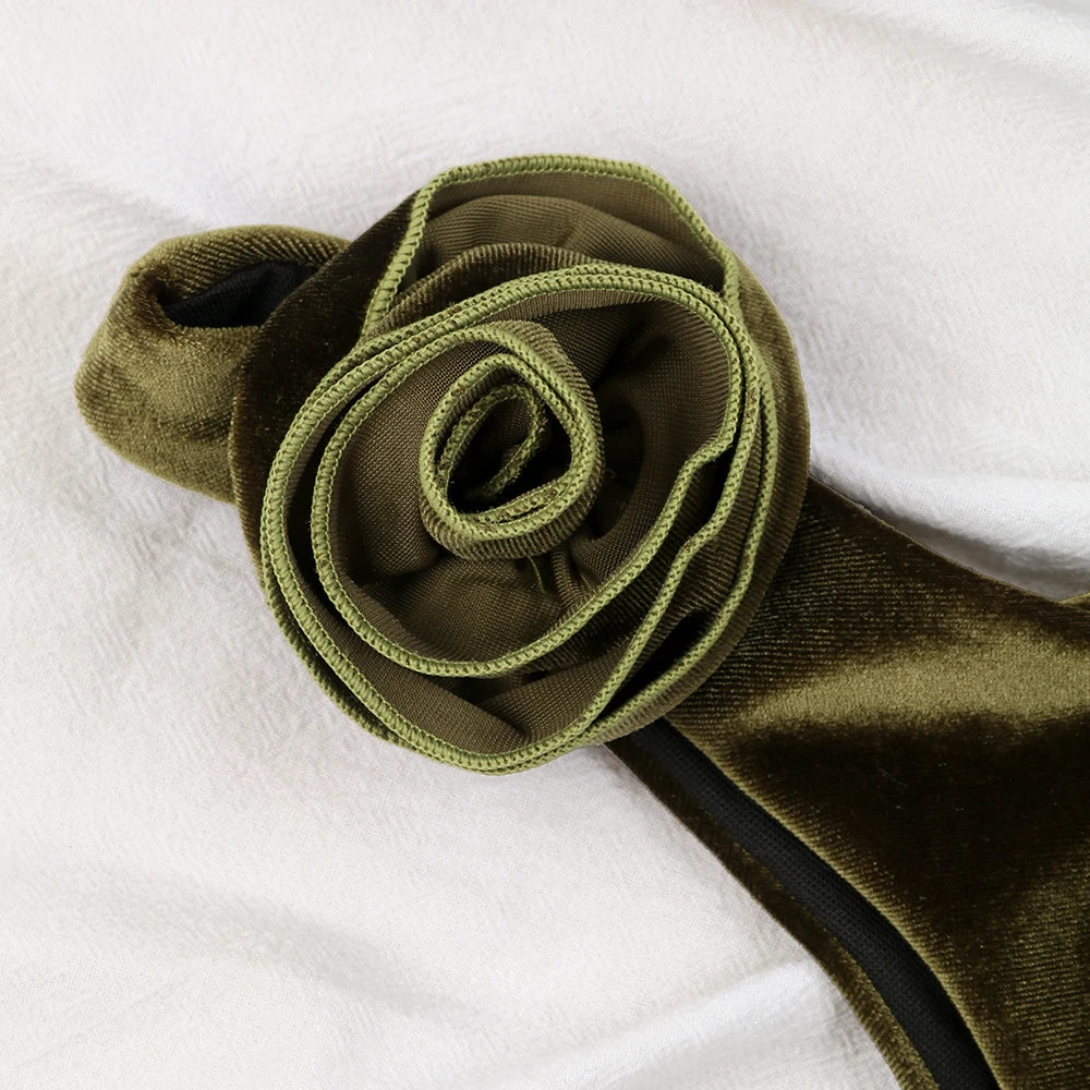 Close-up of velvet rosette detail on bikini top strap