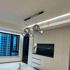 Metallic bubble lava LED chandelier with hanging spheres in modern stairwell setting