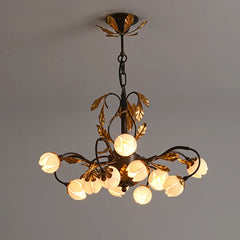 Antique black chandelier with 12 lights and pink tulip-shaped lamp shades, hanging from a ceiling. Golden Atelier 1