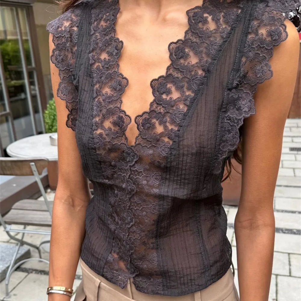 Person wearing a dark lace top outdoors