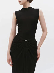 Close-up of metal buckle detail on draped maxi dress
