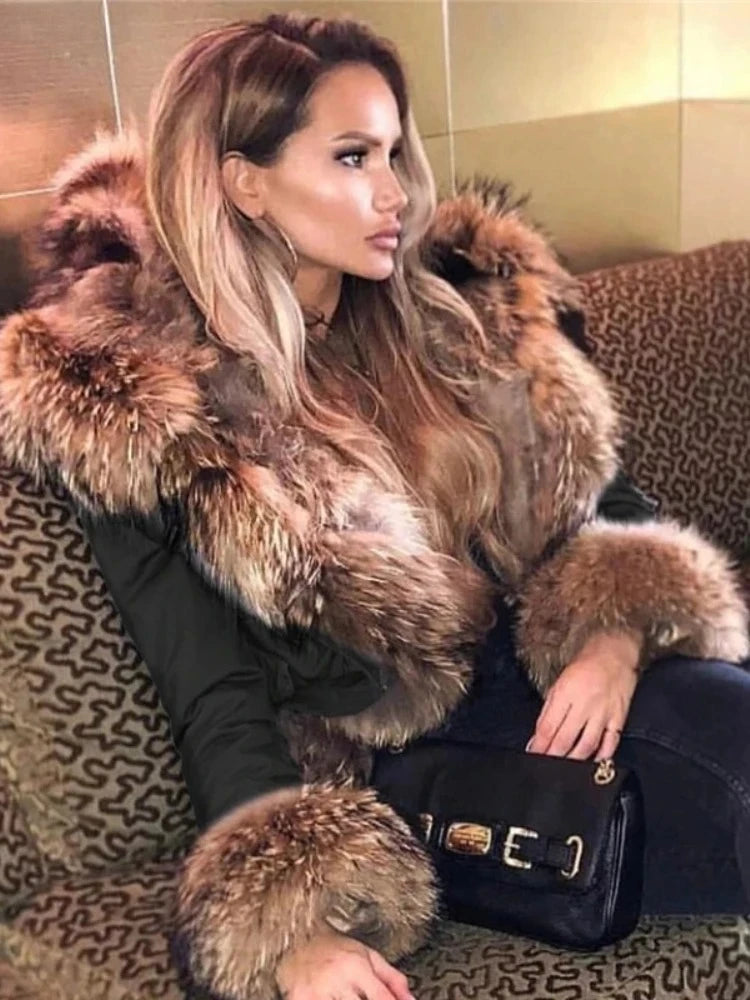 Woman wearing a fur coat sitting on a patterned couch.