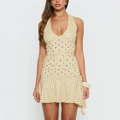 Back view of a polka dot halter neck mini dress