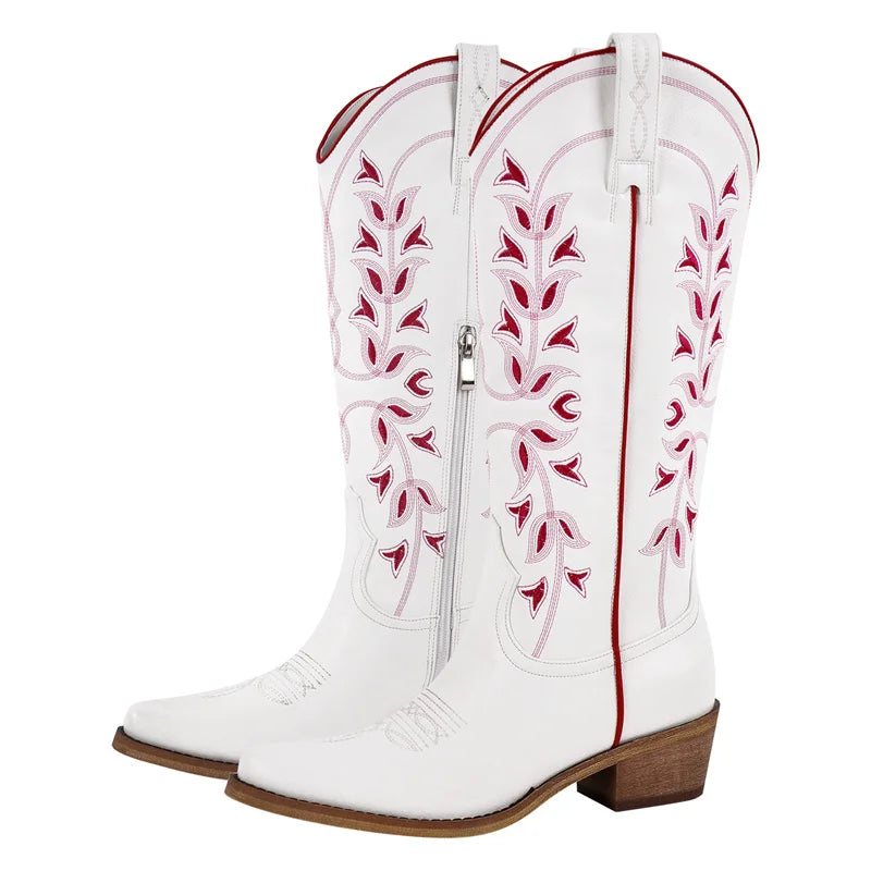 White cowboy boots with red embroidery on a white background