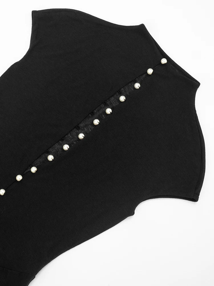 Black sleeveless top with pearl embellishments on a white background