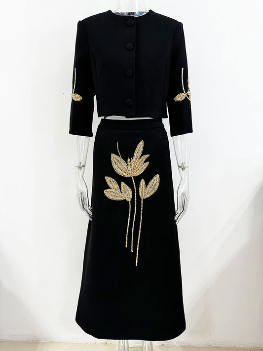 Beaded cropped jacket and midi skirt suit displayed on mannequin