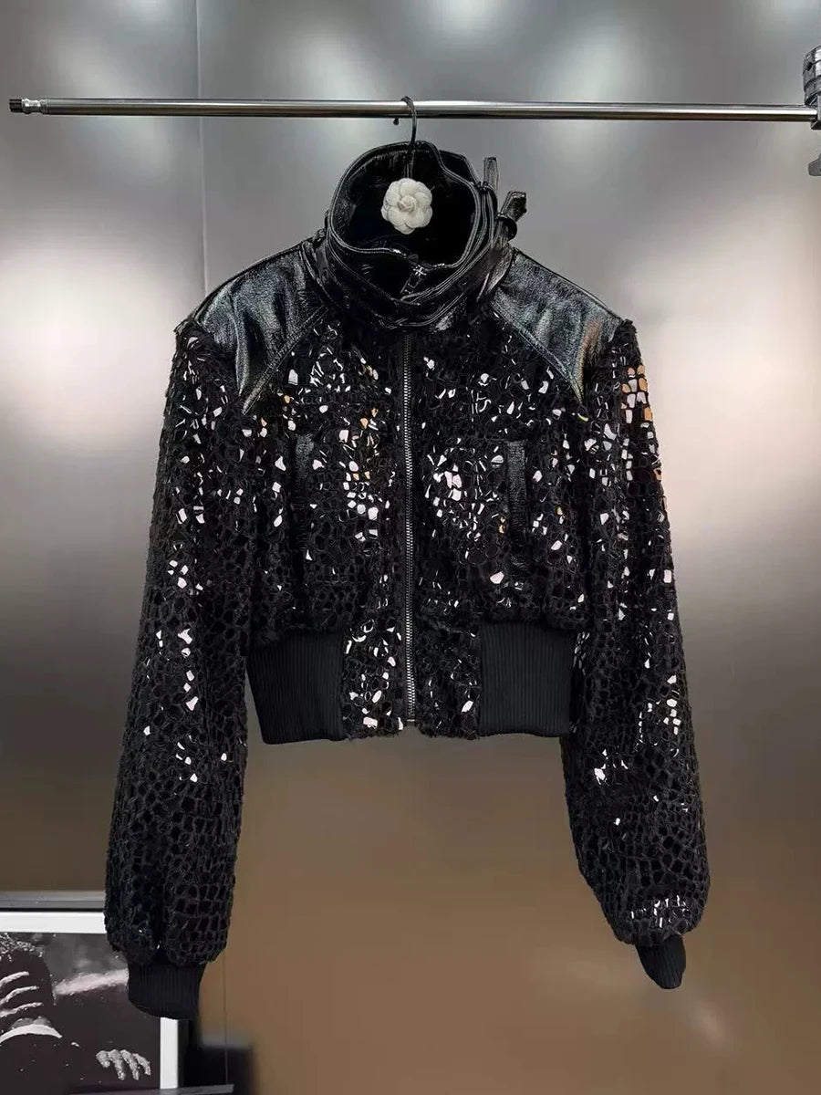 Black sequin jacket on a hanger against a neutral background