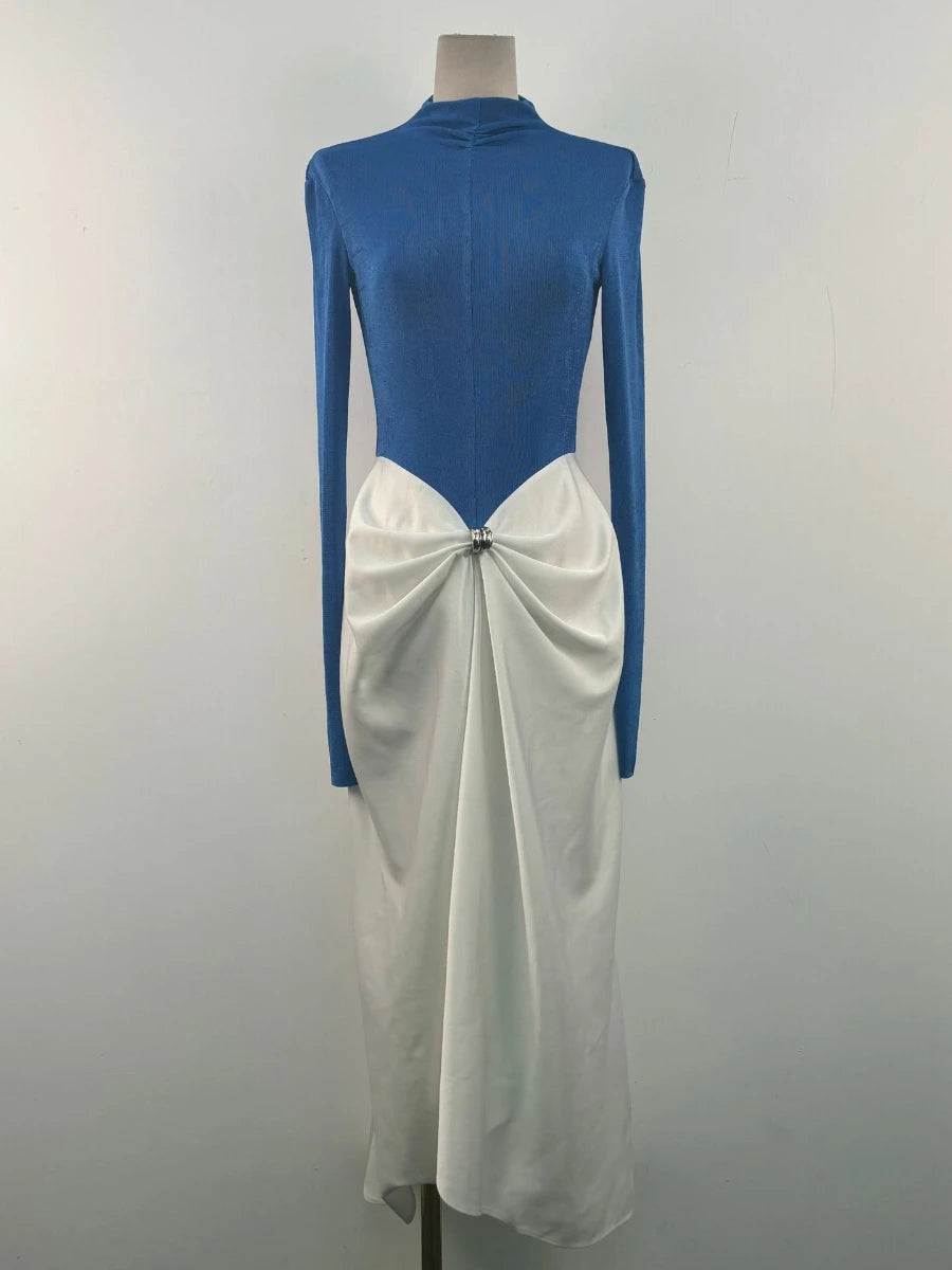 Mannequin wearing a blue and white dress with a bow detail on a plain background