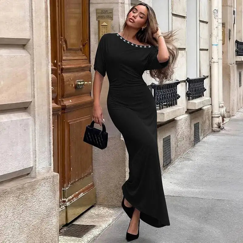 Model wearing a black one-shoulder ruched maxi dress