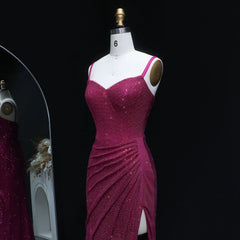 Magenta evening gown on a mannequin against a black background