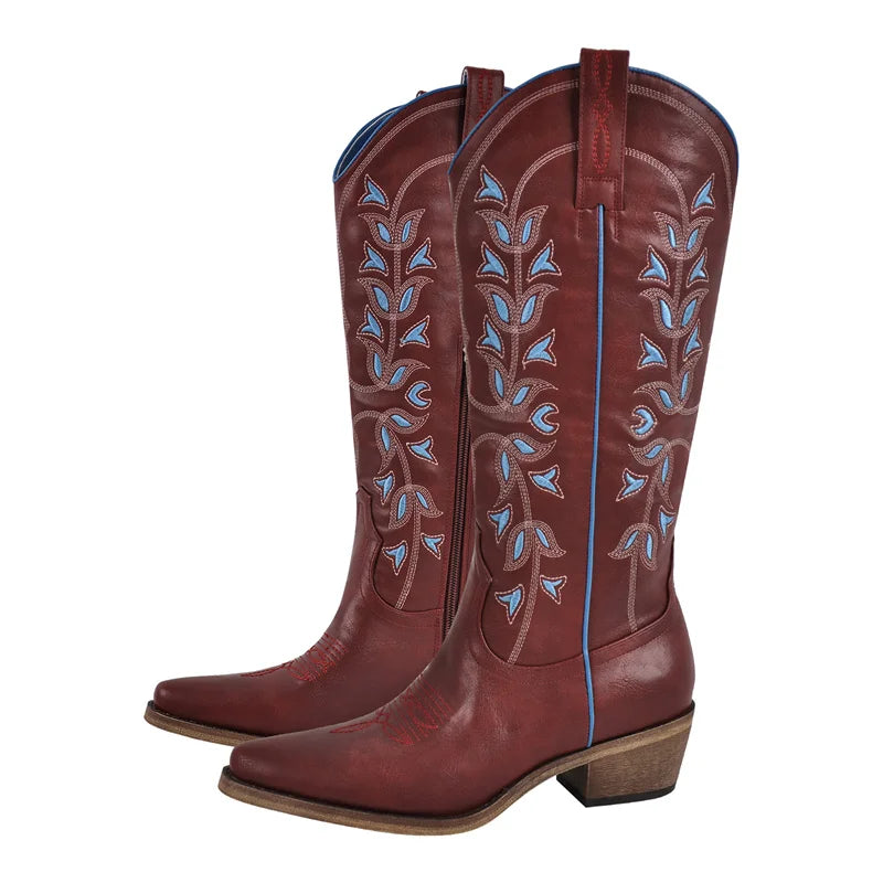 Pair of brown cowboy boots with blue embroidery on a white background